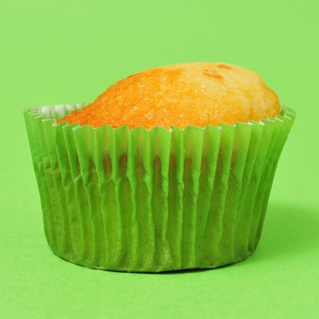 a cupcake with no frosting on a green backgroundの写真素材