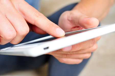closeup of a young man using a tablet computer