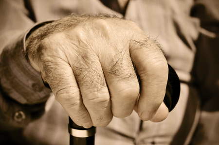 closeup of the hand of an old man with a walking stickの写真素材