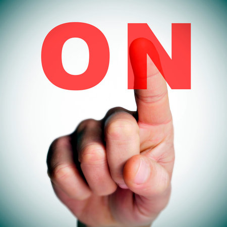 a man finger clicking an on button on a transparent screen