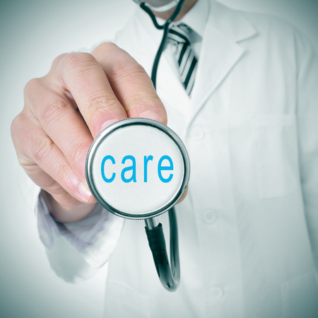 doctor with a stethoscope with the word care written in itの写真素材