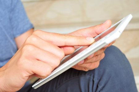 a young man using a tablet computer