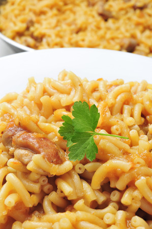 closeup of a plate with fideos a la cazuela, spanish noodles with chicken or porkの写真素材