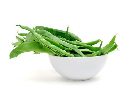 a bowl with green bean pods on a white background