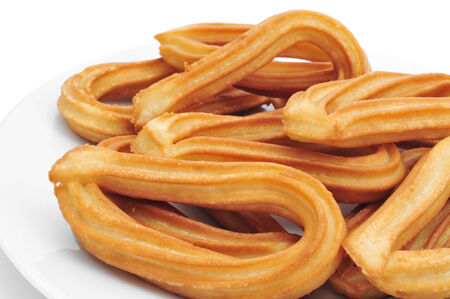 closeup of a plate with churros typical of Spain on a white の写真素材