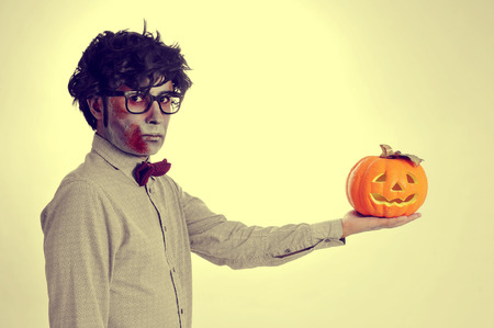 a hipster zombie with a jack-o-lantern in his hand, like Hamlet, with a retro effectの写真素材