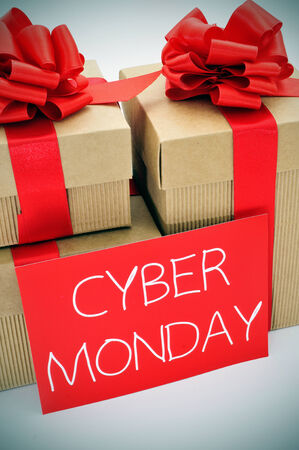 a pile of gifts and the text cyber monday written in white in a red signboardの写真素材