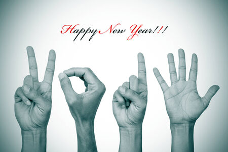 the text happy new year and man hands in black and white forming the number 2015の写真素材