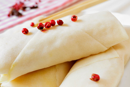 closeup of a plate with some uncooked spring rolls