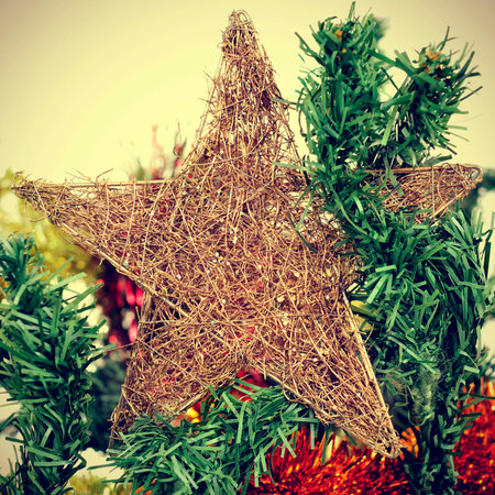 detail of a star topping a christmas tree, with a filter effectの写真素材