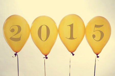 numbers forming 2015, as the new year, on golden balloons, with a filter effectの写真素材