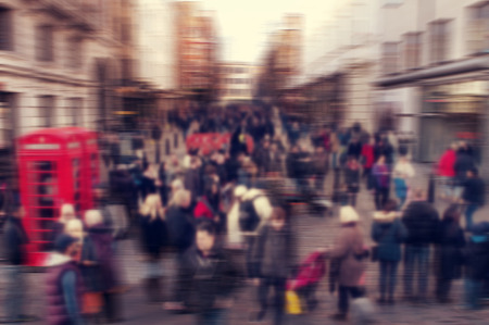 a defocused blur background of people walking in a street in London, United Kingdomの写真素材