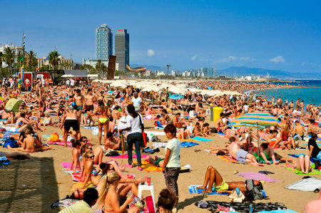 Barcelona, Spain - August 19, 2014: A crowd of bathers in La Barceloneta Beach in Barcelona, Spain. This popular beach hosts about 500000 visitors from everywhere during the summer seasonのeditorial素材