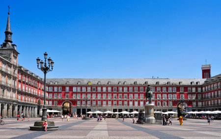 Madrid, Spain - August 11, 2014: People walking in Plaza Mayor square in Madrid, Spain. This popular square dominated by a equestrian statue is the core of the Old Town of the cityのeditorial素材