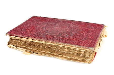 a worn-out old book with a red cover on a white backgroundの写真素材