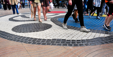 Barcelona, Spain - April 20, 2015: People stepping on the Pla de lOs mosaic in La Rambla in Barcelona, Spain. Thousands of people walk daily on the mosaic, designed by famous Joan Miroのeditorial素材
