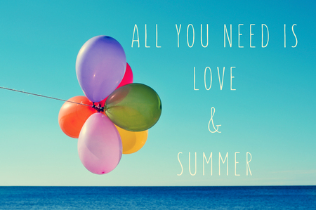 a bunch of balloons of different colors against the blue sky with the sea in the background and the text all you need is love and summerの写真素材