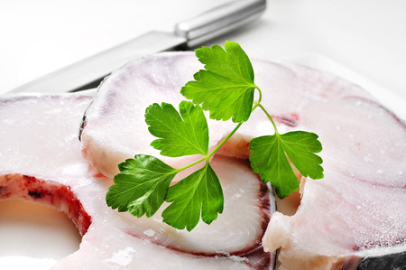closeup of some slices of frozen blue shark on a white worktopの写真素材