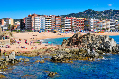 Lloret de Mar, Spain - May 22, 2015: Sunbathers at Platja de Lloret beach in Lloret de Mar, Spain. It is the main beach in this popular tourist village in the Costa Brava, in Cataloniaのeditorial素材