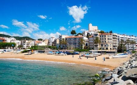 Sant Pol, Spain - May 23, 2015: A view of Platja de les Barques beach and the Ermita de Sant Pau in the top of the hill on in Sant Pol, Spain. Boats, barques in Catalan, give name to this beachのeditorial素材