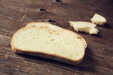 some slices of pan de payes, a round bread typical of Catalonia, Spain, on a rustic wooden surface