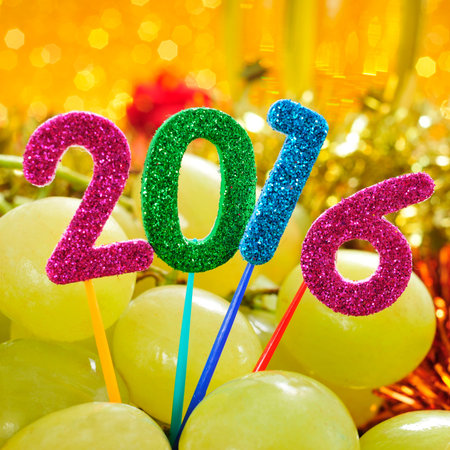 glittering numbers of different colors forming the number 2016, as the new year, with a pile of...