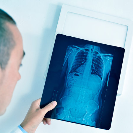 closeup of a young caucasian doctor man observing a skeleton radiograph
