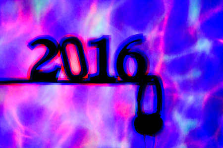colorful lights projected on the number 2016, as the new year, and a pair of headphones in a dance...
