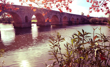 a view of the Puente Romano, an ancient Roman bridge over the Guadiana River, in Merida, Spain, with a filter effectの写真素材