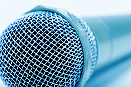 closeup of a microphone, in a blue toningの写真素材