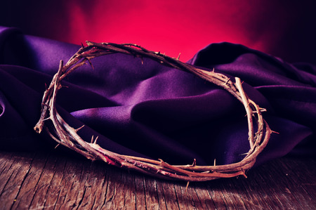 closeup of the the crown of thorns of Jesus Christ on a purple fabricの写真素材