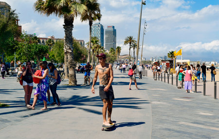 Barcelona, Spain - May 30, 2016: People walking and skatebording in the seafront of La Barceloneta in Barcelona, Spain. The city has a long and busy seafrontのeditorial素材