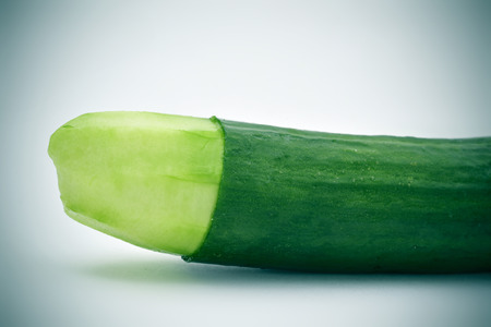 closeup of a cucumber with the skin of its tip removed depicting a circumcised male memberの写真素材