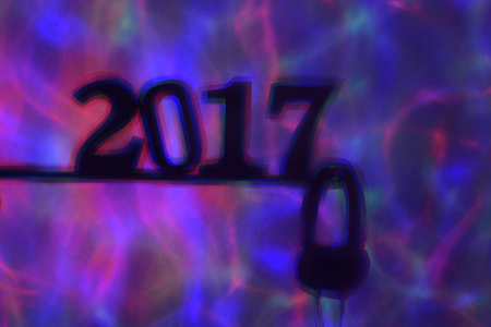 colorful lights projected on a wall and the shadow of the number 2017, as the new year, and a pair of headphones in a dance clubの写真素材