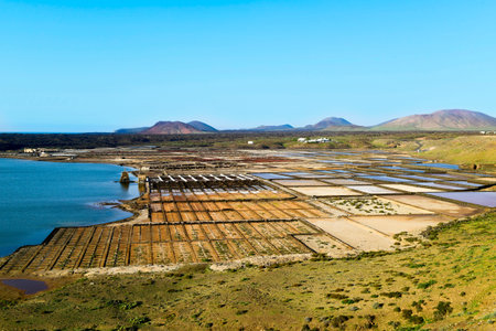 a view of the large saltwater lagoon Laguna de Janubio and the traditional saltworks, in Lanzarote, Canary Islands, Spainの写真素材