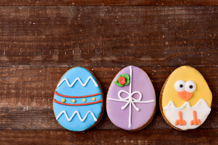 a pile of some different handmade cookies patterned as decorated easter eggs and as a funny chick...
