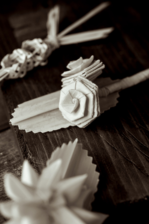 closeup of some small traditional spanish braided palms to be blessed on Palm Sunday on a rustic wooden surfaceの写真素材