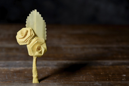 closeup of a small traditional spanish braided palm to be blessed on Palm Sunday on a rustic wooden surfaceの写真素材