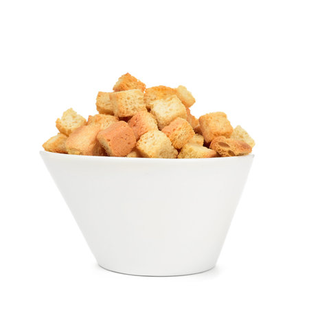 a white ceramic bowl full of croutons on a white backgroundの写真素材