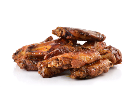 closeup of some barbecue chicken wings on a white backgroundの写真素材