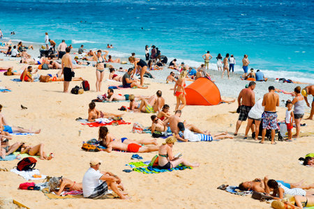 NICE, FRANCE - JUNE 4, 2017: People sunbathing on the beach in Nice, in the French Riviera, France, next to the Promenade des Anglais, the famous seafront walkway of the cityのeditorial素材