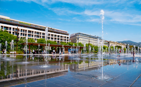 NICE, FRANCE - JUNE 4, 2017: A view of the reflecting pool of the Promenade du Paillon in Nice, France. This pool in the large public park has 128 water jets, that delight childrenのeditorial素材