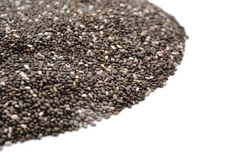 closeup of a pile of chia seeds on a white backgroundの写真素材