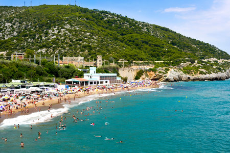 SITGES, SPAIN - JULY 9, 2017: People enjoying, relaxing, sunbathing or bathing at the Garraf Beach...