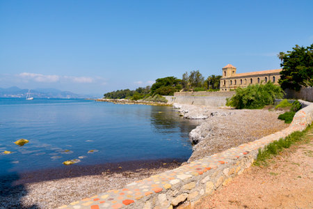 a view of the Lerins Abbey in the Saint-Honorat island, France, with the coast of Cannes in the backgroundのeditorial素材