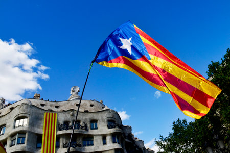 BARCELONA, SPAIN - SEPTEMBER 11, 2017: An estelada, the Catalan independentist flag in Barcelona, Spain, during a rally for the independence of Catalonia, and the famous Casa Mila in the backgroundのeditorial素材