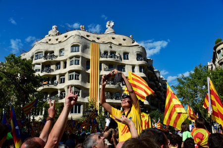 BARCELONA, SPAIN - SEPTEMBER 11, 2017: People in Barcelona, Spain, partaking in a rally in support for the independence of Catalonia, highlighting the famous Casa Mila or La Pedrera in the backgroundのeditorial素材
