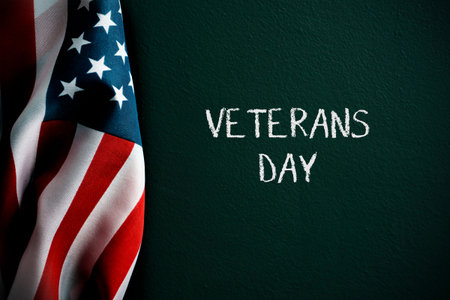 an american flag and the text veterans day against a dark green backgroundの写真素材
