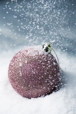 closeup of an elegant christmas ball on the snowの写真素材