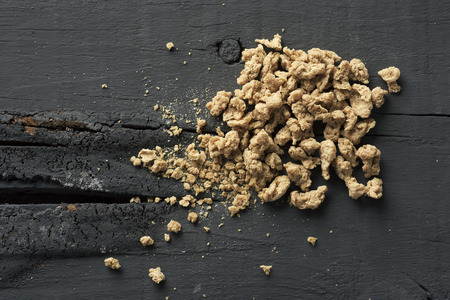 high angle view of some chunks of textured soy protein on a gray rustic wooden tableの写真素材